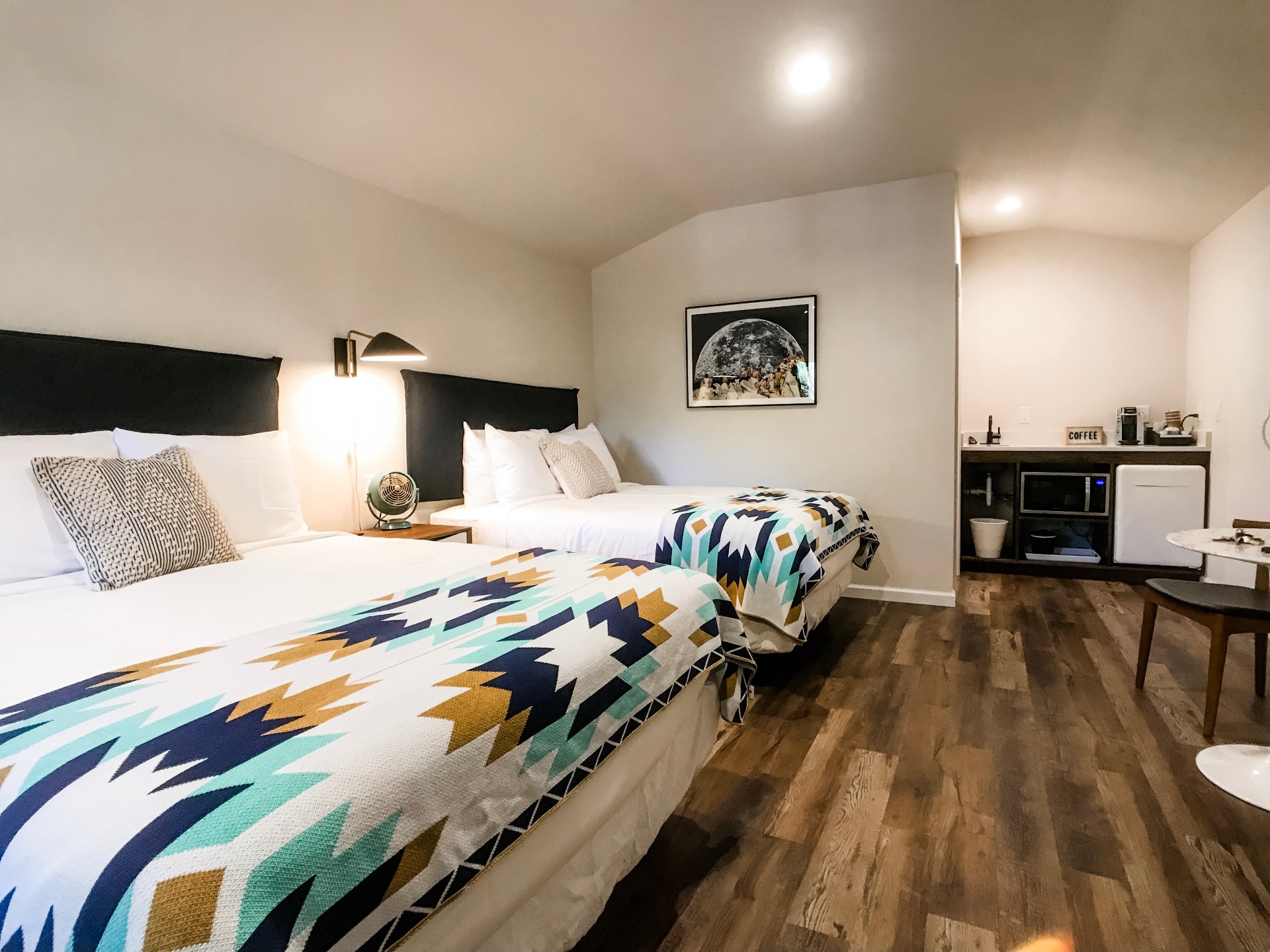 Guest room with double beds and mid-century decor